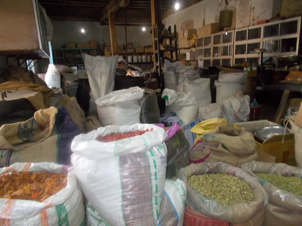 Sacks of spices and dried produce stacked inside a spice warehouse in Kochi